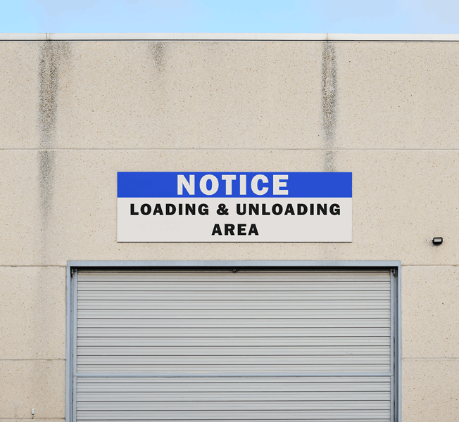 Custom outdoor aluminum safety sign on exterior of Cavendish Farms facility in Jamestown, ND.
