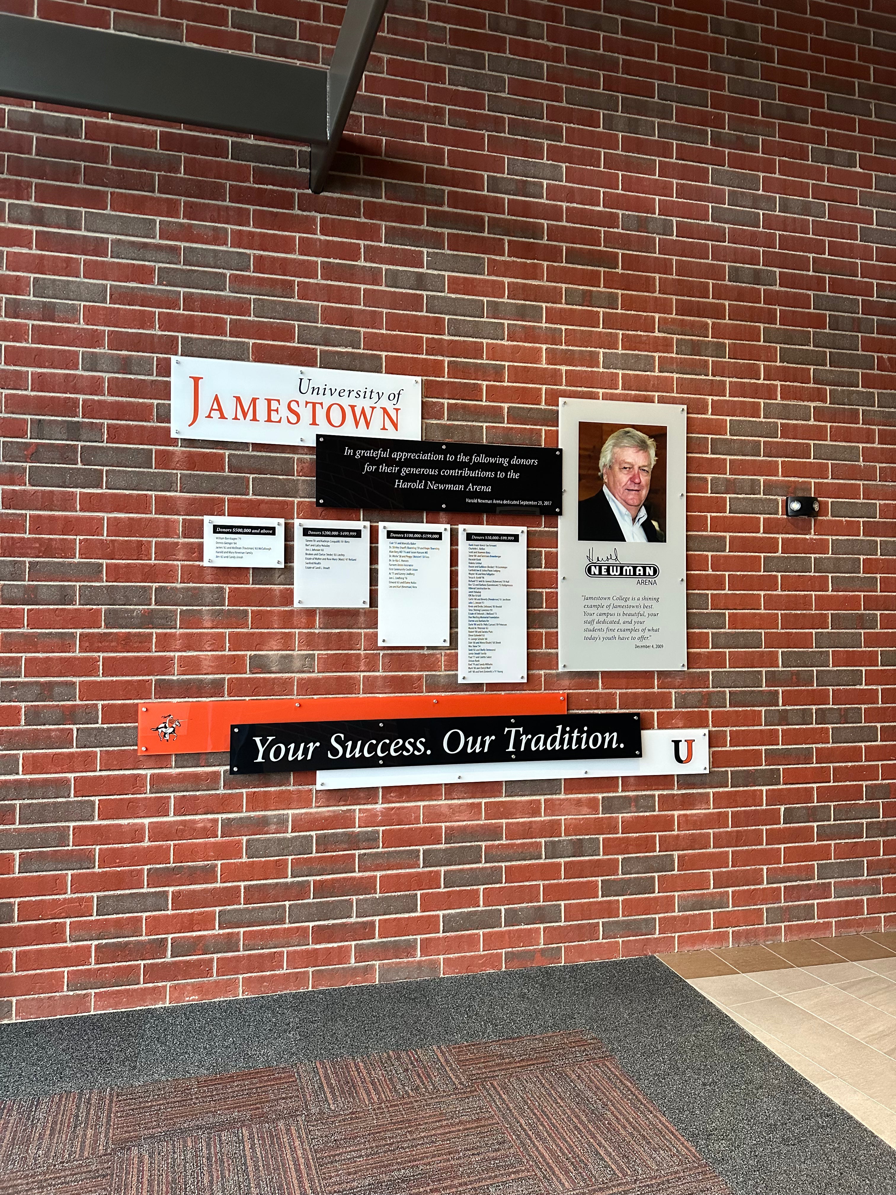 wall-mounted acrylic display showcasing school donors and tradition