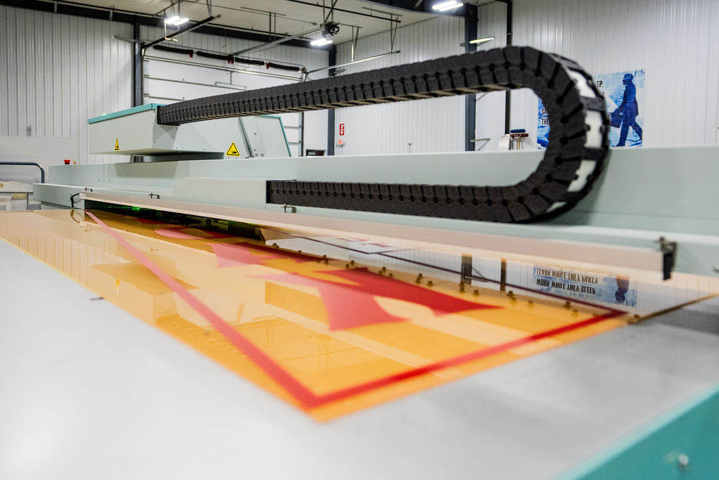 Large industrial printing machine with a colorful design on a flatbed in Newman Print - Jamestown, ND.