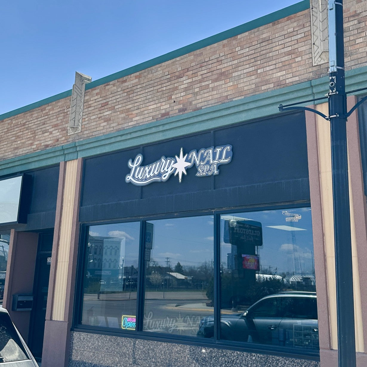 Custom-cut ACM exterior business sign for Luxury Nail Spa Building in Jamestown, ND.