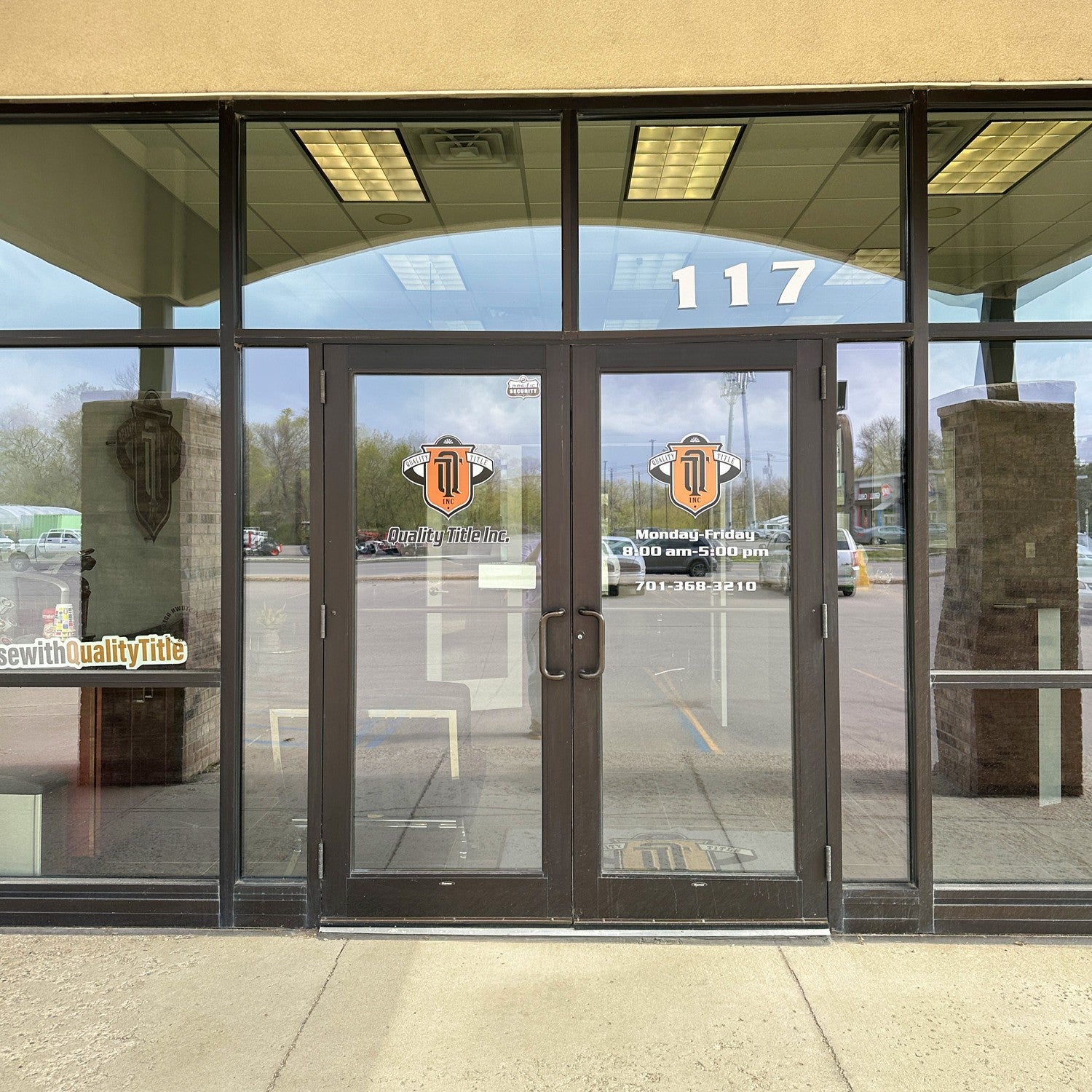 Custom window decals for Quality Title Inc. storefront business branding in Jamestown, ND.