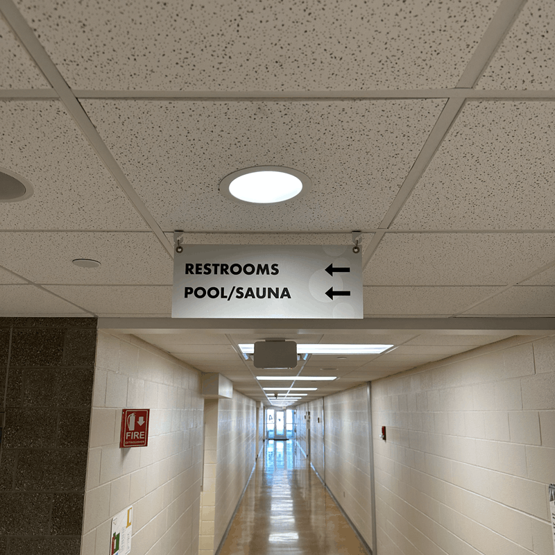 Custom hanging indoor wayfinding site sign for Parks and Rec facility in Jamestown, ND.