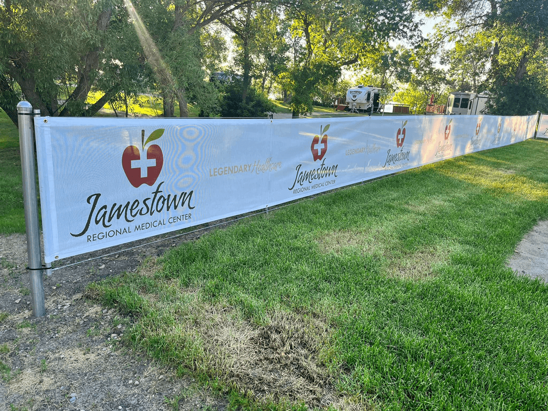 Custom wind resistant sponsor mesh banners for sand volleyball court in Spiritwood, ND.