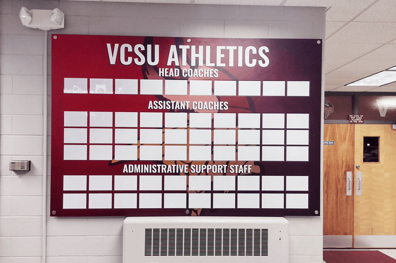 VCSU Athletics sign with a grid for head, assistant coaches, and administrative support staff on ACM Poly Metal in Valley City, ND.