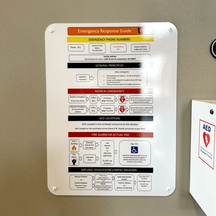 Custom emergency response aluminum sign wall mounted on campus for colleges and universities in Jamestown, ND.