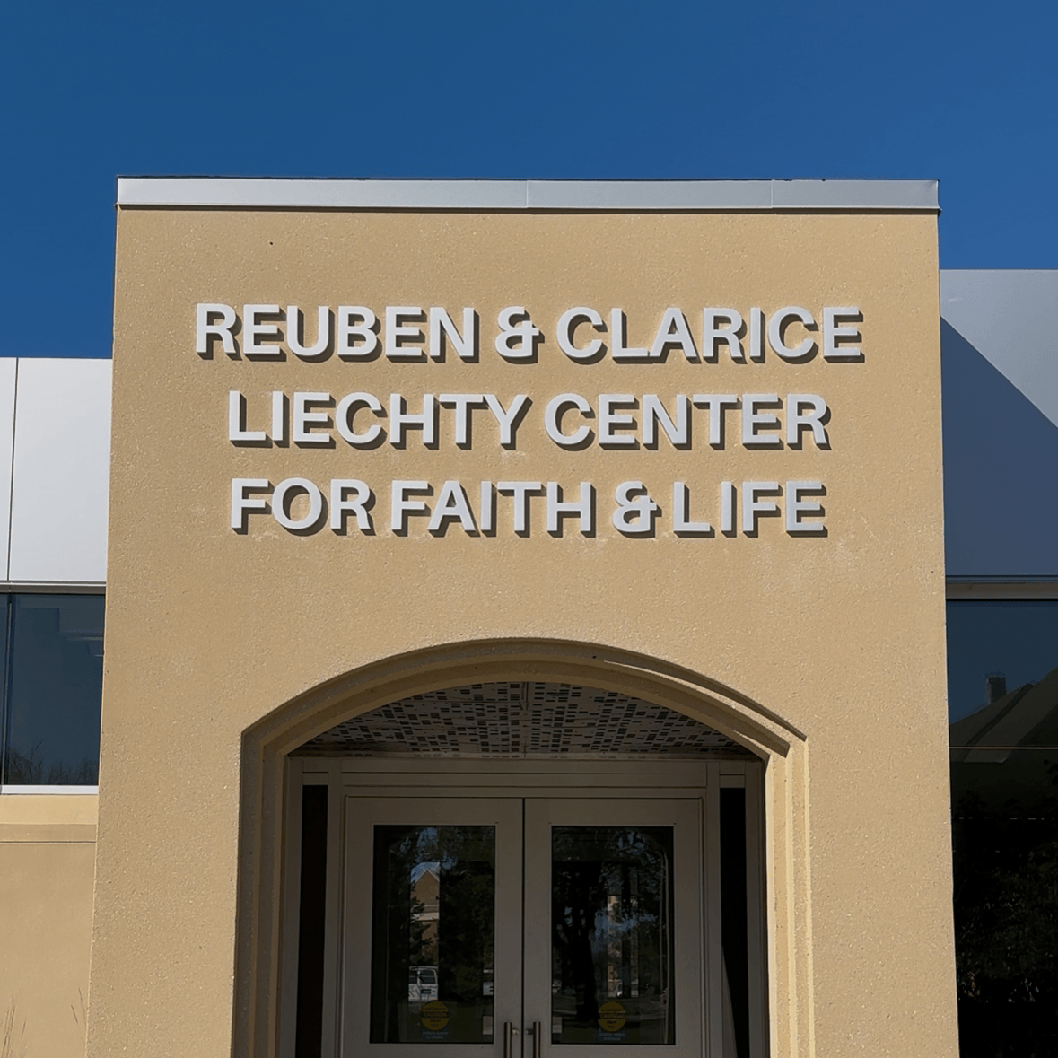Beige building with 'Reuben & Clarice Liechty Center for Faith & Life' sign on a University campus building in Jamestown, ND.