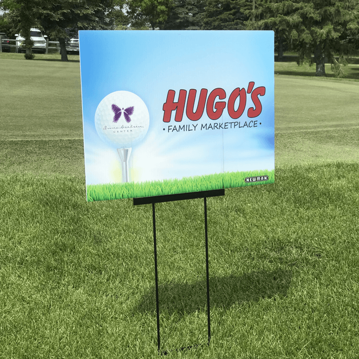 Outdoor sign for 'Hugo's Family Marketplace' on a golf course in Jamestown, ND.