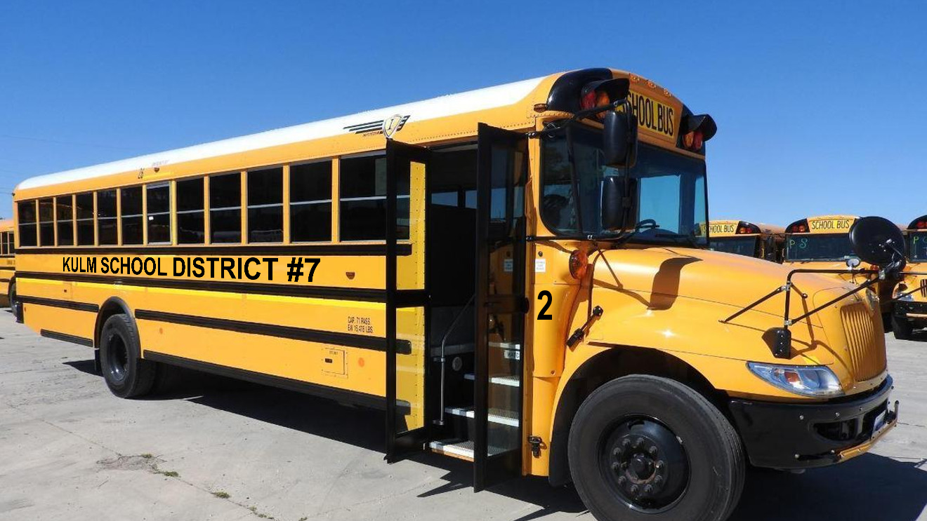 Yellow school bus with 'Kulm School District #7' DECALS on a clear day