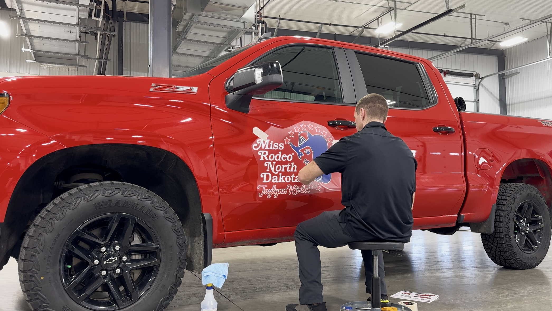 Nick installing decals onto a vehicle.