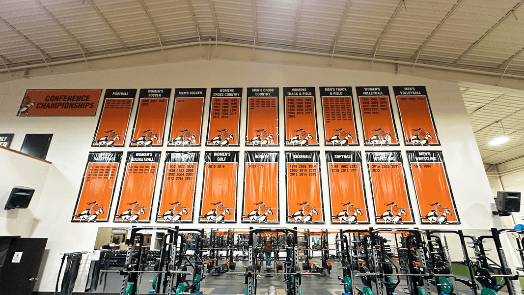 Custom indoor vinyl banners for University weight room wall in Jamestown, ND.