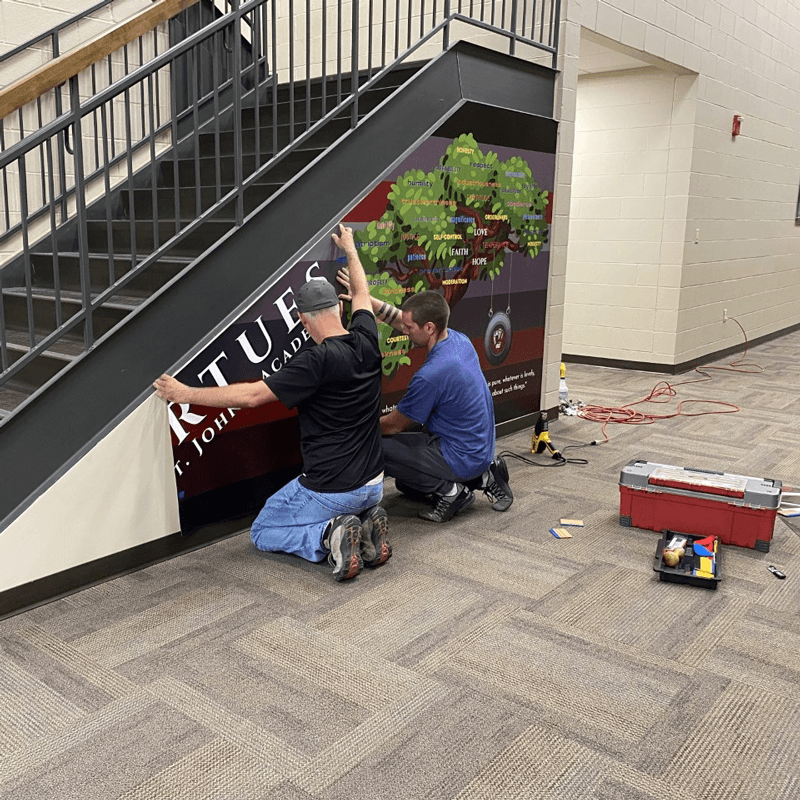 Newman Print team installing wall mural graphics.